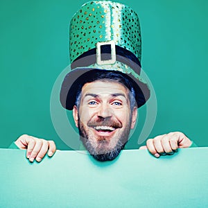 Lucky Patricks day. Man on green background celebrate St Patricks Day. Man in Saint Patrick`s Day leprechaun party hat photo