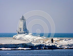 Ludington`s North Breakwater Light in Mason County, Michigan Lighthouse in the Winter with sightseers. photo