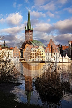 Luebeck, old town view with St. Petri church in red brick architecture with reflection the the river Trave, famous city in