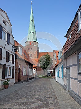 Luebeck Travemuende, narrow lane with church St. Lorenz