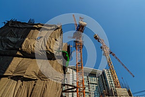 Luffing jib tower crane at condominium construction site over st
