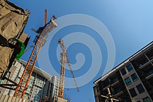 Luffing jib tower crane at condominium construction site over st