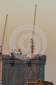 Luffing jib tower crane at condominium construction site over st