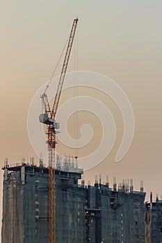 Luffing jib tower crane at condominium construction site over st