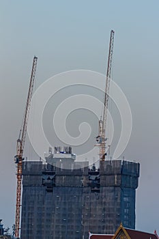 Luffing jib tower crane at condominium construction site over st