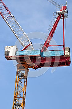Luffing jib tower crane soars into blue sky