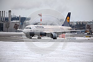 Lufthansa plane doing taxi in Munich Airport in winter