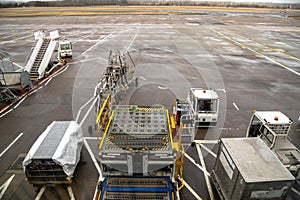 Luggage Cart and Other Handling Equipment on the Tarmac of an Airport