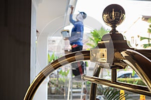 Luggage cart trolley at hotel lobby with male worker in the background