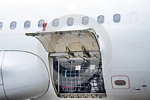 Luggage compartment and cargo section in the airplane open on inspection, with bags and luggage of passengers.