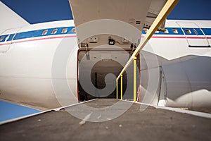 Luggage compartment and cargo section in the airplane open ready to accept bags