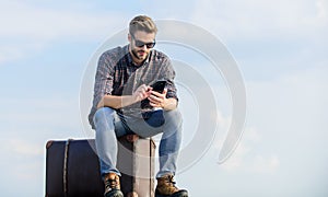 Luggage concept. Handsome traveler. Guy outdoors with vintage suitcase. Calling taxi. Travel agency. Travel with luggage