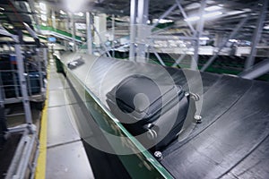 Luggage on conveyor belt in blurred motion at airport