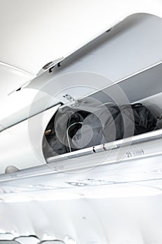 Luggage on the top airplane shelf overhead passenger seat