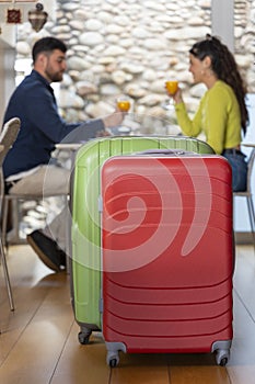 Luggage of young tourist couple in love having breakfast in a hotel