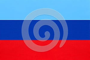 Luhansk People`s Republic national fabric flag from textile. Symbol of unrecognised state of Ukraine