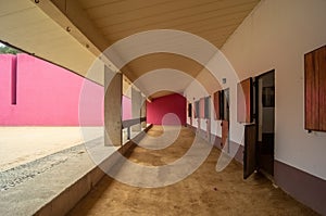 Luis Barragan's Cuadra San Cristobal pink wall, endemic vegetation and sandy ground in the background photo