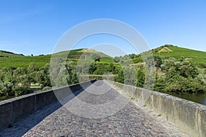 Luitpold bridge over river Nahe in Oberhausen with vineyards and blue sky