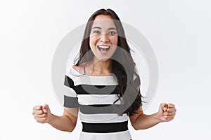 Luky, enthusiastic good-looking east-asian brunette girl motivated, determined win, clench fists empowered, smiling photo