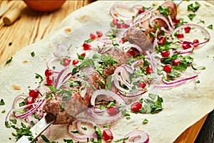 Lula kebab, Georgian dish with meat served by onions and greens in pita bread