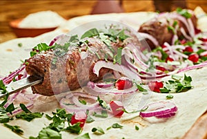 Lula kebab, Georgian dish with meat served by onions and greens in pita bread