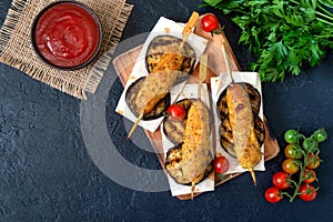 Lula kebab with grilled eggplant on pita bread. chicken kebabs on a skewer with vegetables