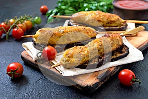 Lula kebab with grilled eggplant on pita bread. chicken kebabs on a skewer with vegetables