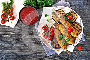 Lula kebab with grilled eggplant on pita bread. Dietary chicken kebabs on a skewer with vegetables