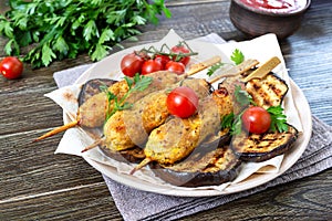 Lula kebab with grilled eggplant on pita bread. Dietary chicken kebabs on a skewer with vegetables