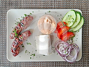 Lula kebab with a side dish of fresh vegetables