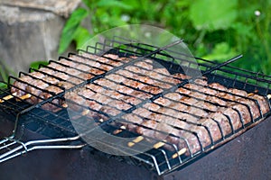 Lulya kebab from meat are prepared in the grill. Shish kebab in the grill.