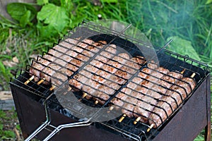 Lulya kebab from meat are prepared in the grill. Shish kebab in the grill.