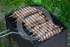 Lulya kebab from meat are prepared in the grill. Shish kebab in the grill.