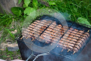 Lulya kebab from meat are prepared in the grill. Shish kebab in the grill.