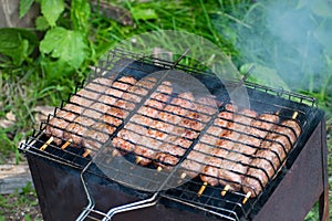 Lulya kebab from meat are prepared in the grill. Shish kebab in the grill.