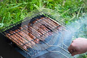 Lulya kebab from meat are prepared in the grill. Shish kebab in the grill.