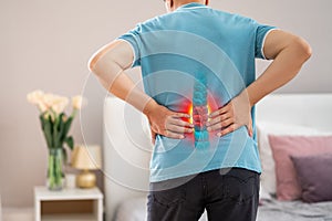 Lumbar spine hernia, man with back pain at home, compression injury of the intervertebral disc in the lower back