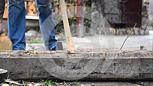 Lumber jack man chopping wood logs with ax.