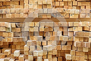 Lumber in sawmill, ends of timber blocks for texture background. Sawed and processed wood in storage