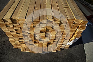 Lumber stacked in a bundle at a construction site