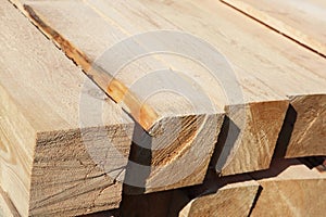 Lumber stacked in a row at the sawmill, lumber stack for storage construction