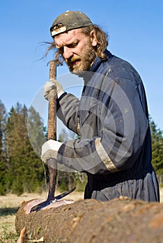 Lumber worker removing bark