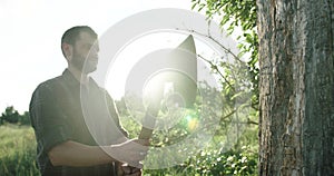 Lumberjack with the ax in the forest.Stylish lumberman getting ready for work. Hard iwork in the forest. Lumberjack