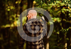 Lumberjack carry ax. bald woodsman worker. live on rancho. concept of masculinity. bearded hipster cut tree. man