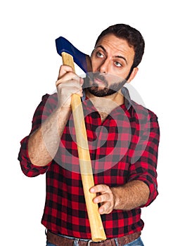 Lumberjack shaves his beard with the ax blade