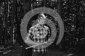 Lumberjack standing with axe on forest background. Deforestation is a major cause of land degradation and