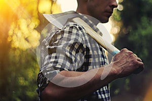 Lumberjack in the woods with an ax photo