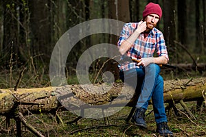 A lumberjack in the woods resting