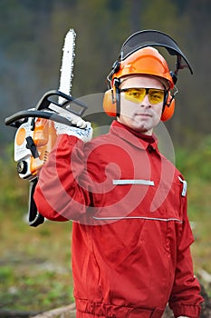 Lumberjack Worker With Chainsaw In The Forest