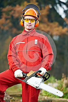 Lumberjack Worker With Chainsaw In The Forest